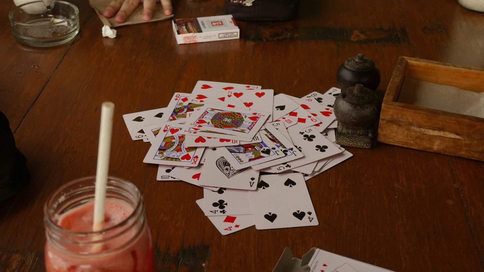 a table with cards and a drink